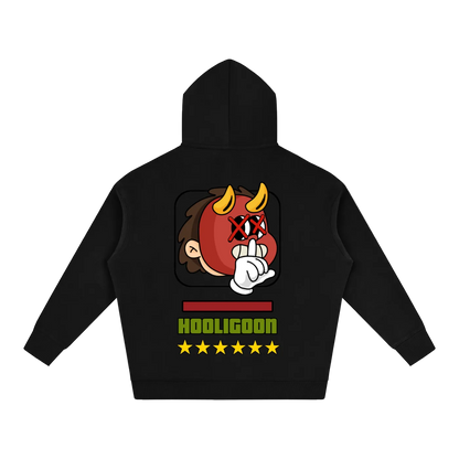 A black pullover hoodie shown from the back, featuring a graphic of a cartoon devil face with yellow horns, a red mask, and a hand gesture. Below the graphic is the text 'HOOLIGOON' in green and yellow, accompanied by five yellow stars, all on a plain white background.